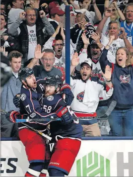  ?? [KYLE ROBERTSON/DISPATCH] ?? Brandon Dubinsky, left, and David Savard celebrate Dubinsky’s goal that tied the score at 4 in the third period.