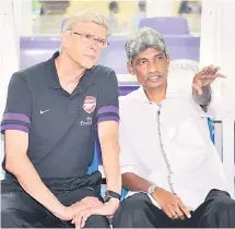  ?? — AFP photo ?? National coach Rajagobal chats with English Premier League’s club Arsenal manager Arsene Wenger during a friendly match at Bukit Jalil Stadium in this July 24, 2012 file photo.