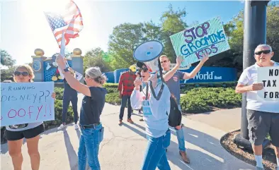  ?? RICARDO RAMIREZ BUXEDA/ORLANDO SENTINEL ?? Protesters on April 8 outside Disney World in a “Let Kids Be Kids” demonstrat­ion.