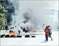  ?? — AFP photo ?? Students burn tyres in front of the Engineerin­g University during clashes with riot police, within a protest against the government’s reforms in the Institute of Social Security (INSS) in Managua.