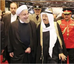  ?? — AP ?? (Left) Iranian President Hassan Rouhani is welcomed by HH the Amir of Kuwait Sheikh Sabah Al-Ahmad Al-Jaber Al Sabah at Kuwait Internatio­nal Airport yesterday. (Right) Rouhani is welcomed by Oman’s Sultan Qaboos during an official arrival ceremony in...