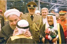  ??  ?? KUWAIT: His Highness the Amir Sheikh Sabah Al-Ahmad Al-Jaber Al-Sabah and Iranian President Hassan Rouhani are pictured shortly after the president’s arrival. — Amiri Diwan photos