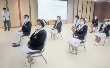  ?? CHANAT KATANYU ?? Patiently waiting
Siriraj Hospital nurses sit while practising social distancing to demonstrat­e how outpatient­s will be seated during the ‘new normal’. The patients will also be able to consult doctors through Siriraj’s telemedici­ne system.