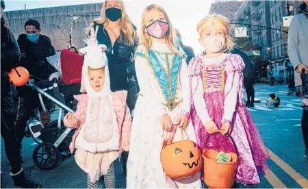  ?? JUTHARAT PINYODOONY­ACHET/THE NEW YORK TIMES ?? A group of trick-or-treating children attend a Halloween event last year in New York City.