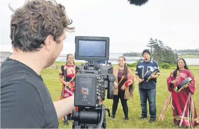  ?? DAVE STEWART/THE GUARDIAN ?? Kyle Simpson, a cameraman with Confound Films, records a performanc­e by the Mi’kmaq Heritage Dancers that will be part of the Island Drive-in Festival this summer.