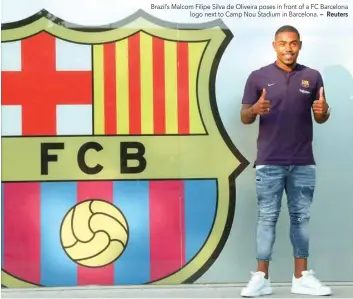  ?? — Reuters ?? Brazil’s Malcom Filipe Silva de Oliveira poses in front of a FC Barcelona logo next to Camp Nou Stadium in Barcelona.