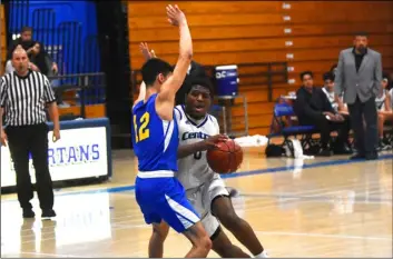  ?? PHOTO AARON BODUS ?? Central’s Khalil Wyatt shoulders his way past Brawley’s Oscar Gonzalez in the second quarter of the Spartans’ eventual 57-54 overtime win over the Wildcats on Thursday in El Centro.