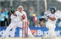  ?? Picture: AFP ?? BAILS FLY: Sri Lankan batsman Kumar Sangakkara, right, watches as South African wicketkeep­er Quinton de Kock, left, unsuccessf­ully attempts to stump him at the Galle Internatio­nal Cricket Stadium yesterday