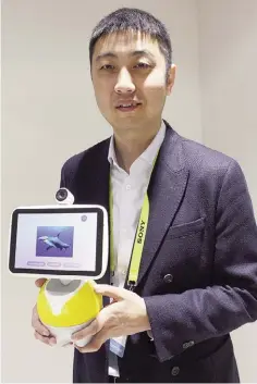  ??  ?? LAS VEGAS: Jing Kun, general manager of operating system DuerOS powering a new Baidu digital valet, shows off the “Little Fish” home assistant unit at the 2017 Consumer Electronic­s Show in Las Vegas on January 5, 2017. —AFP