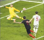  ?? Thanassis Stavrakis / Associated Press ?? Croatia’s Mario Mandzukic, center, scores his side’s second goal during Wednesday’s semifinal match against England.