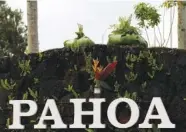  ?? AP FILE PHOTO BY CALEB JONES ?? Offerings sit on a sign welcoming people to Pahoa, Hawaii, in May.