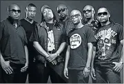  ??  ?? BLUE COLLAR: Skwatta Kamp, with Flabba, centre