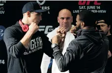  ?? JONATHAN HAYWARD/ THE CANADIAN PRESS ?? Rory MacDonald of Canada, left, and Tyron Woodley of the U. S. face off in a promotion for their fi ght at Rogers Arena.