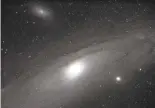  ??  ?? Astronomer­s Jeff Crawford and William Phelps captured this image of the Andromeda Galaxy, with a Perseidmet­eor streaking through, in an undated photograph taken at Glacier Point.
