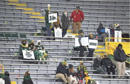  ?? MARK HOFFMAN / MILWAUKEE JOURNAL SENTINEL ?? A small number of fans watch the Green Bay Packers play the Chicago Bears on Nov. 29 at Lambeau Field in Green Bay.