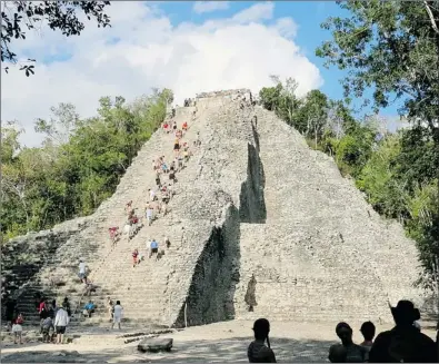  ?? PHOTOS: DAVID YATES/ THE GAZETTE ?? Visitors swarm up the Nohoch Mul pyramid at Coba a few days after Christmas. At 42 metres, it is said to be the tallest in the Yucatan and towers above Kukulkan at Chichen Itza and the Pyramid of the Magician at Uxmal, well-known sites in the Yucatan...