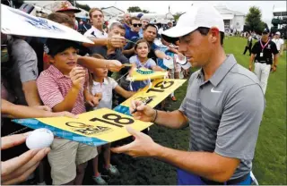  ?? The Associated Press ?? Rory McIlroy signs autographs on Tuesday after a practice round for this week’s PGA Championsh­ip at Quail Hollow Club in Charlotte, N.C. The tournament starts on Thursday.