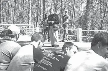  ?? Gazette file photo ?? Nedra Turney, chairwoman of the Miller County Conservati­on District Board, awards students during a Land Judging and Forestry Clinic at Camp Preston Hunt. Students demonstrat­ed skills used by profession­al foresters.