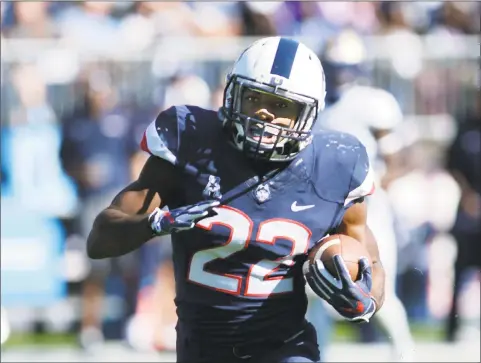  ?? Stephen Dunn / Associated Press ?? UConn running back Arkeel Newsome gains yardage in the first half against Tulsa on Saturday in East Hartford.