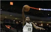  ?? AARON GASH ?? In this Oct. 17, 2019, file photo, Milwaukee Bucks’ Khris Middleton (22) shoots after driving past Minnesota Timberwolv­es’ Jake Layman during the first half of a preseason NBA basketball game in Milwaukee.