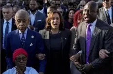  ?? Mike Stewart/Associated Press ?? The Rev. Al Sharpton, Vice President Kamala Harris and Attorney Ben Crump walk and sing across the Edmund Pettus Bridge on Sunday with others commemorat­ing the 59th anniversar­y of the Bloody Sunday voting rights march in 1965 in Selma, Ala.