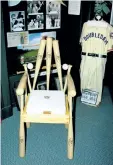  ?? BARB FOX/SPECIAL TO POSTMEDIA NEWS ?? A chair made from baseball bats and balls, and vintage uniforms are on display.