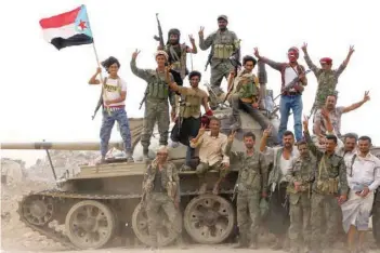  ?? — Reuters ?? Members of southern Yemeni fighters stand atop a tank during clashes with government forces in Aden.