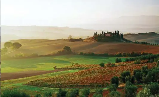  ??  ?? A sinistra, scorcio di un paese delle Langhe, la zona collinare che si estende tra le province di Cuneo e Asti, con le Alpi sullo sfondo. A destra, vitigni in Val d’Orcia, a nord-est del monte Amiata e vicino al confine con l’Umbria.