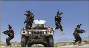  ?? RAHMAT GUL/AP 2021 ?? Afghan soldiers patrol outside their military base in May on the outskirts of Kabul, Afghanista­n.