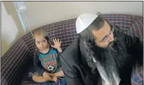  ??  ?? ‘TRAUMATISE­D’: Eight-year-old Nathan Nakesh with his father, Nahman, at the hotel on Wednesday