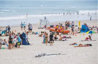  ??  ?? Crowds enjoying the first day of 2018 at Surfers Paradise beach.