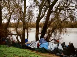  ?? MAX WHITTAKER/NEW YORK TIMES ?? An encampment along the American River in Sacramento, Calif., on Jan. 9.