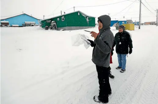  ?? PHOTOS: AP ?? US Census workers verify that their maps match the number of houses in Toksook Bay, Alaska, a mostly Yup’ik village on the edge of the Bering Sea. Census workers traditiona­lly begin the official count in rural Alaska before the spring melt. The rest of the country, including more urban areas of Alaska, will begin the census in mid-March.