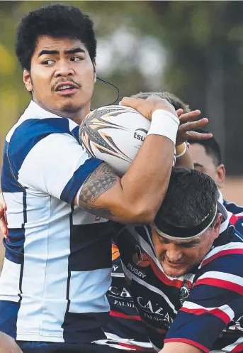  ?? Pictures: JUSTIN KENNEDY ?? Casuarina's Andrew Stephens looks to pass after confrontin­g the Palmerston defence during NTRU action at Rugby Park yesterday. Palmerston’s Jai Wyles-Kelly