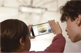  ?? Google ?? Earthlings look over the solar system using technology from Project Tango. Tango, which is a bid to create machines with a better sense of what’s around them, uses software and sensors to track motions and size up the contours of rooms.