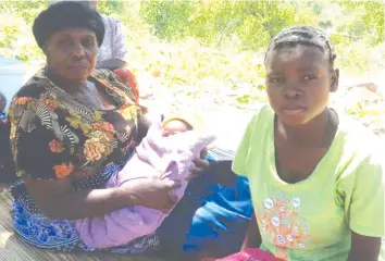  ??  ?? Mhlanga (right) with her mother-in-law gogo Mutama holding the baby. — Picture by Luthando Mapepa