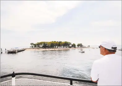  ?? Bob Luckey Jr. / Hearst Connecticu­t Media ?? Bill Wright, of Greenwich, looks toward Island Beach from the bow of the Island Beach ferry on Saturday.