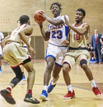  ?? Andrew Stein/For the Post-Gazette ?? McKeesport’s Deamontae Diggs makes a move toward the basket in a game against Penn Hills Friday night at McKeesport. Penn Hills won, 81-48.