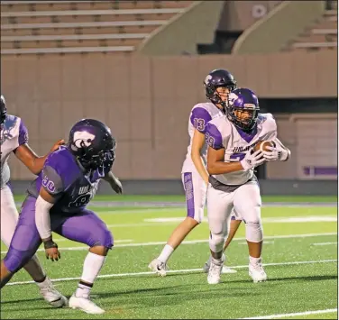  ?? Penny Chanler/Special to the News-Times ?? Room to run: El Dorado’s Elijah Davis looks for running room during the Purple & White Game at Memorial Stadium last month. The Wildcats travel to Camden Fairview for their season opener tonight. Game time is at 7 p.m.