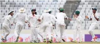  ??  ?? Bangladesh­i players celebrate their victory against Australia during the fourth day of their first Test cricket match in Dhaka Wednesday. (AP)