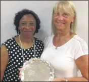  ??  ?? Lynne Gray, right, receives her award from Marlene Wander, chairman of Kent Netball