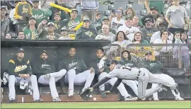  ?? JEFF CHIU — THE ASSOCIATED PRESS ?? Tigers left fielder Mike Gerber cannot catch a foul ball hit by the Athletics’ Jed Lowrie in front of the Oakland bullpen during the seventh inning Saturday night at the Colisuem.