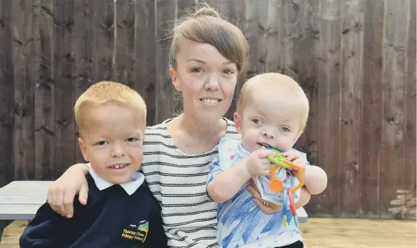  ??  ?? Laura Phillips with sons Nathan and Jax.