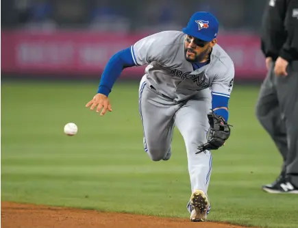  ?? AP PHOTO ?? Toronto Blue Jays second baseman Devon Travis fields a ball hit by Ian Kinsler of the Los Angeles Angels during the eighth inning of Friday’s game in Anaheim, Calif. Travis threw Kinsler out on the play but the Angels went on to win 2-1.