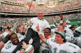  ?? THE ASSOCIATED PRESS FILE PHOTO ?? Miami Dolphins coach Don Shula is carried on his team’s shoulders after his 325th victory, against the Philadelph­ia Eagles in Philadelph­ia. Sports in 2020 was an unending state of mourning.