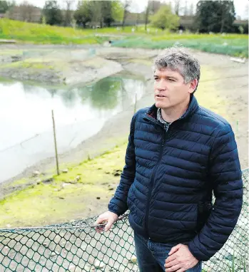  ?? MIKE BELL ?? Vancouver park board biologist Nick Page looks over the salt marshes at New Brighton Park, one of the natural areas the board is working to “rewild” and restore through its biodiversi­ty strategy.