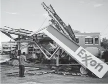  ?? John Taggart / New York Times ?? The remnants of Hurricane Ida caused damage throughout the Northeast, including to an Exxon station in New York.