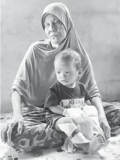  ??  ?? Tom and her grandson Amar Darwish. — Bernama photo