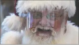  ?? (AP/Ashley Landis) ?? Santa Claus wears a face shield while visiting with children at Bass Pro Shop in Rancho Cucamonga, Calif.