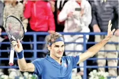  ?? — AFP photo ?? Roger Federer celebrates after winning against Borna Coric to move to within one win of a 100th career title.